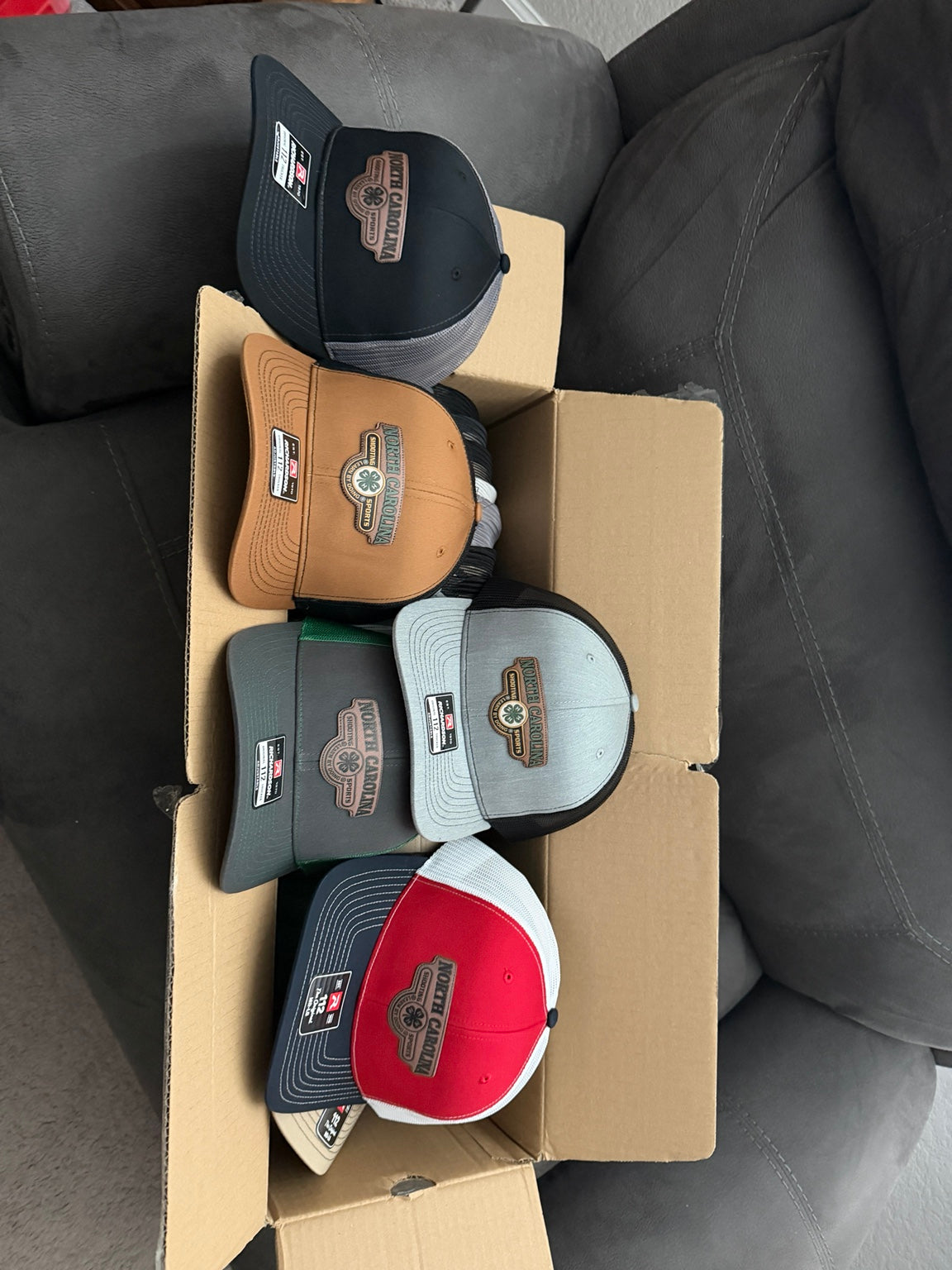 Assorted finished custom hats with patches